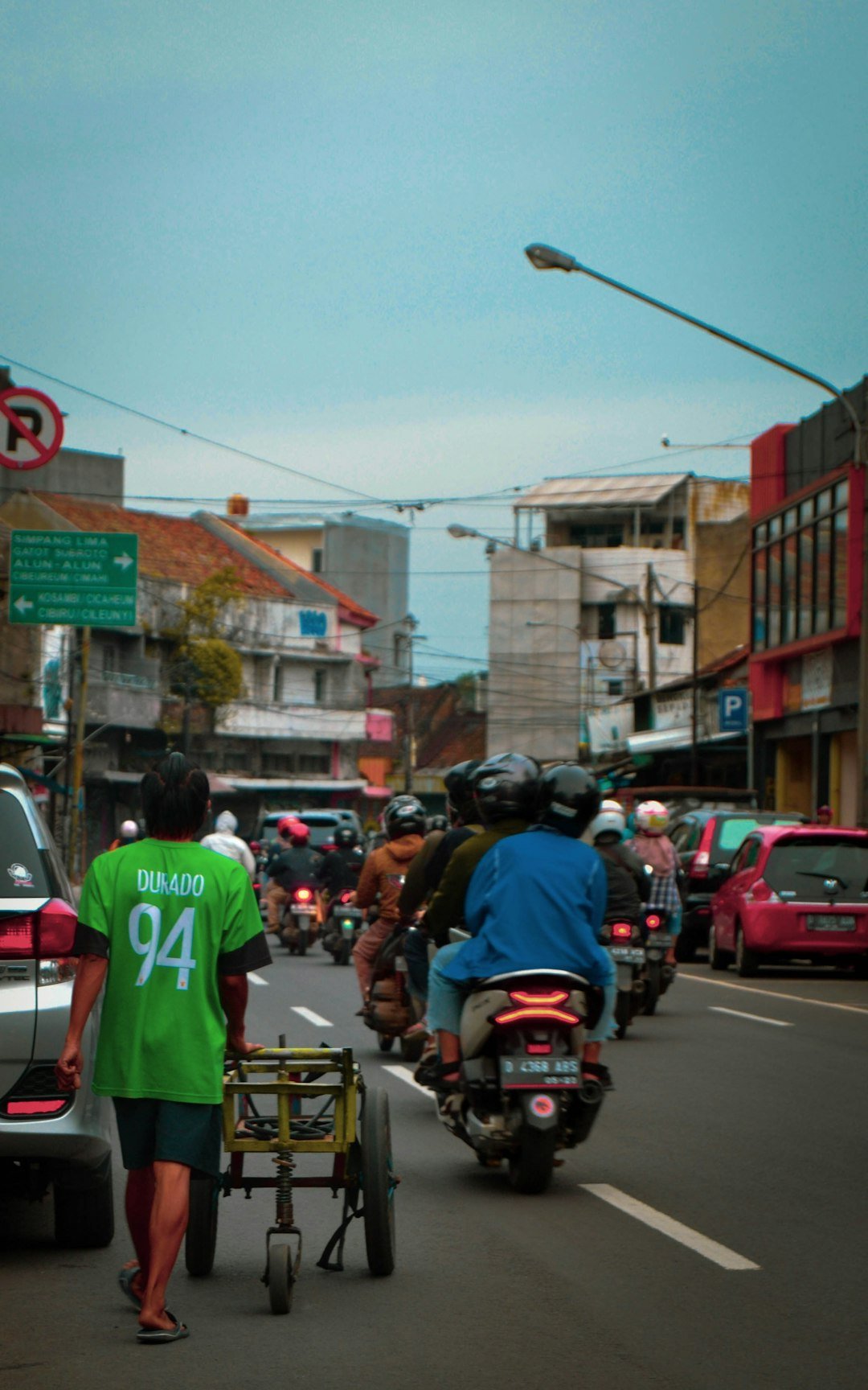 a group of people riding motorcycles down a street