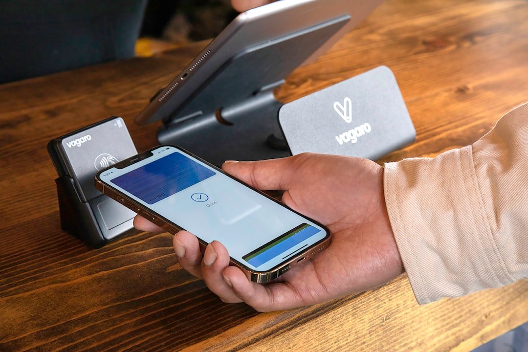 a person holding a cell phone in their hand
