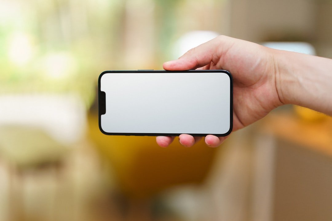 A person holding a cell phone in their hand