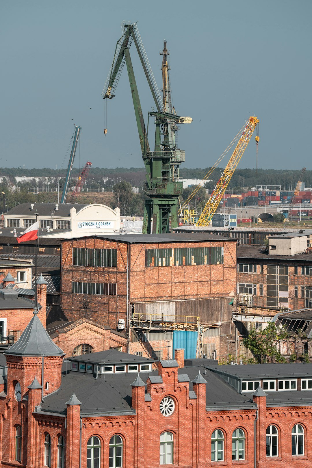 A large crane on top of a tall building