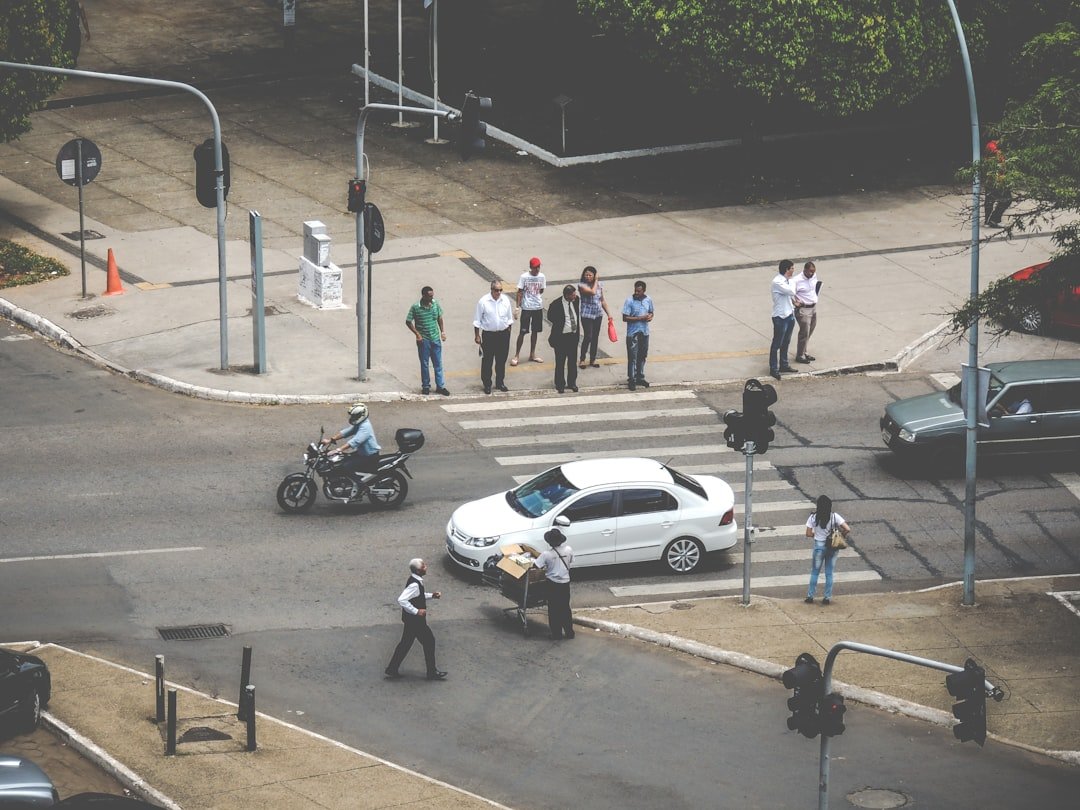 white car on ped xing